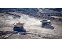 Two diesel-electric trucks used in modern mines and quarries for hauling industrial quantities of ore or coal. Used when extra torque is needed for steep hills. Queensland, Australia. Logos removed.